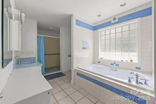 a spacious bathroom with a granite countertop sink a mirror and a