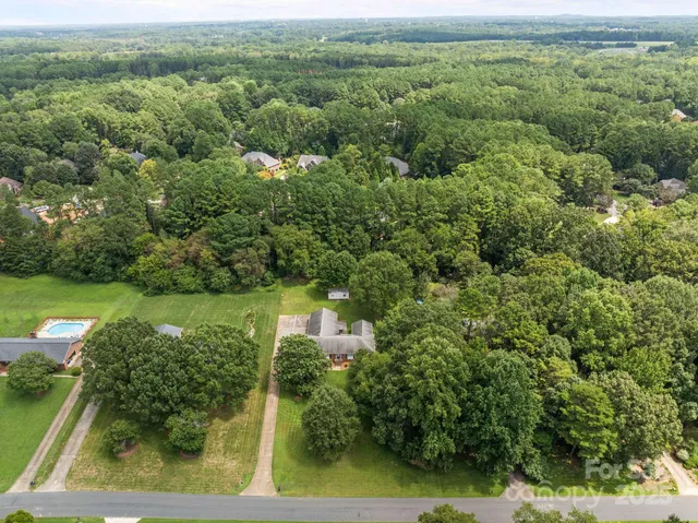 an aerial view of a residential houses with trees