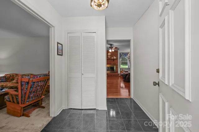 a view of a hallway with wooden shelves