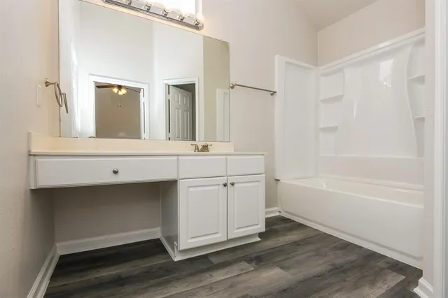 a bathroom with a sink a mirror and a bathtub