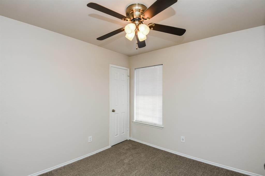 6900 Chaco Trail Fort Worth, TX 76137 - Photo 12 of 17 an empty room with a window and a fan