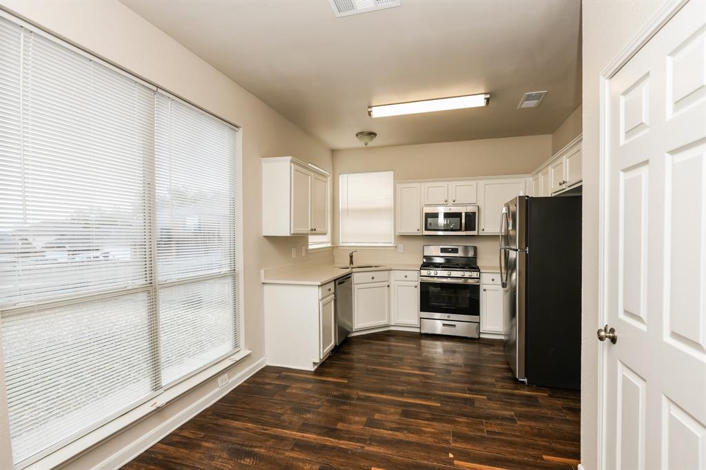 6900 Chaco Trail Fort Worth, TX 76137 - Photo 6 of 17 a kitchen with granite countertop a refrigerator and a stove top oven