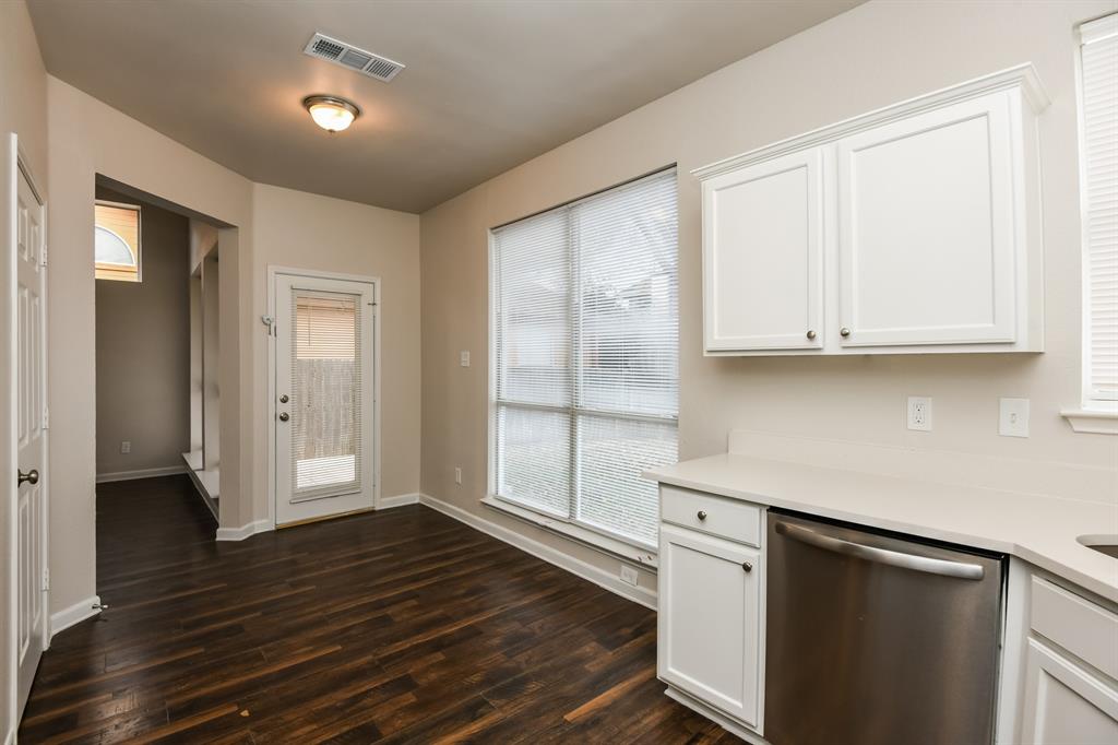 6900 Chaco Trail Fort Worth, TX 76137 - Photo 8 of 17 a view of a kitchen with wooden floor and cabinets