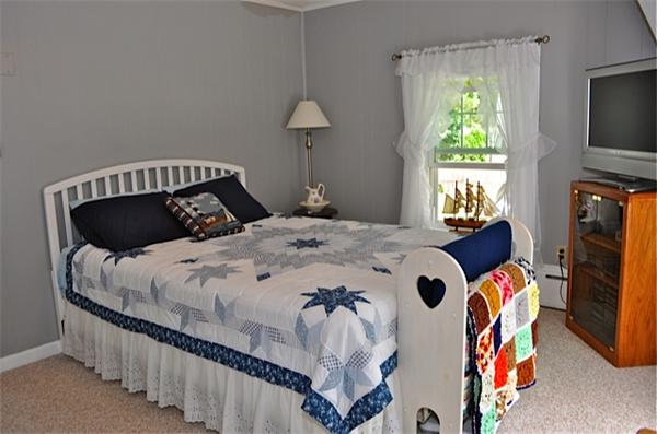 9 Wianno Road Marion, MA 02738 - Photo 9 of 10 a bedroom with a bed and a flat tv screen on dresser