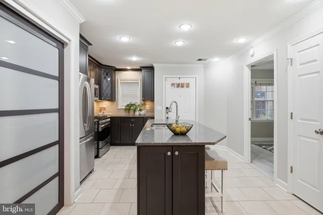 a kitchen with refrigerator and cabinets