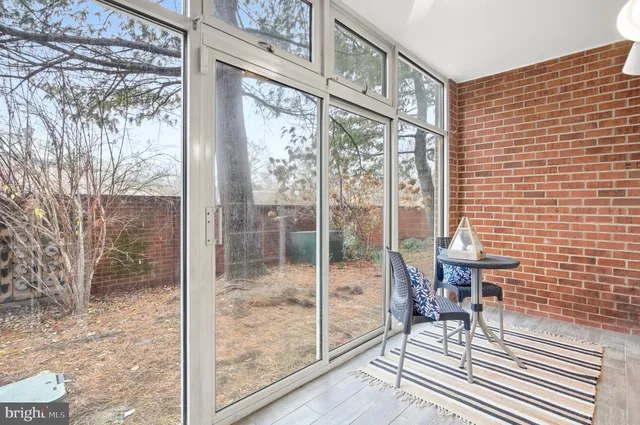 a view of a room with a balcony and furniture