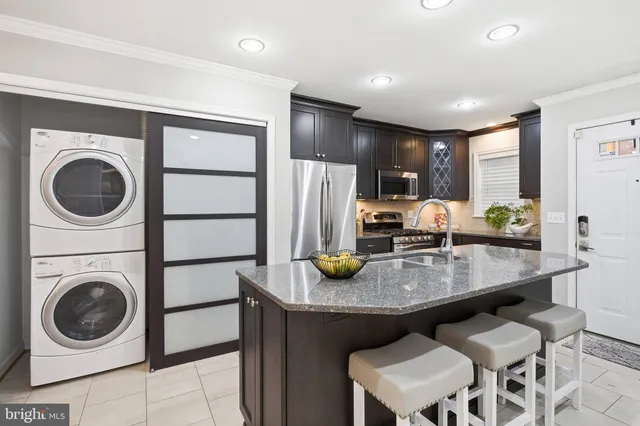 a kitchen with sink refrigerator and cabinets
