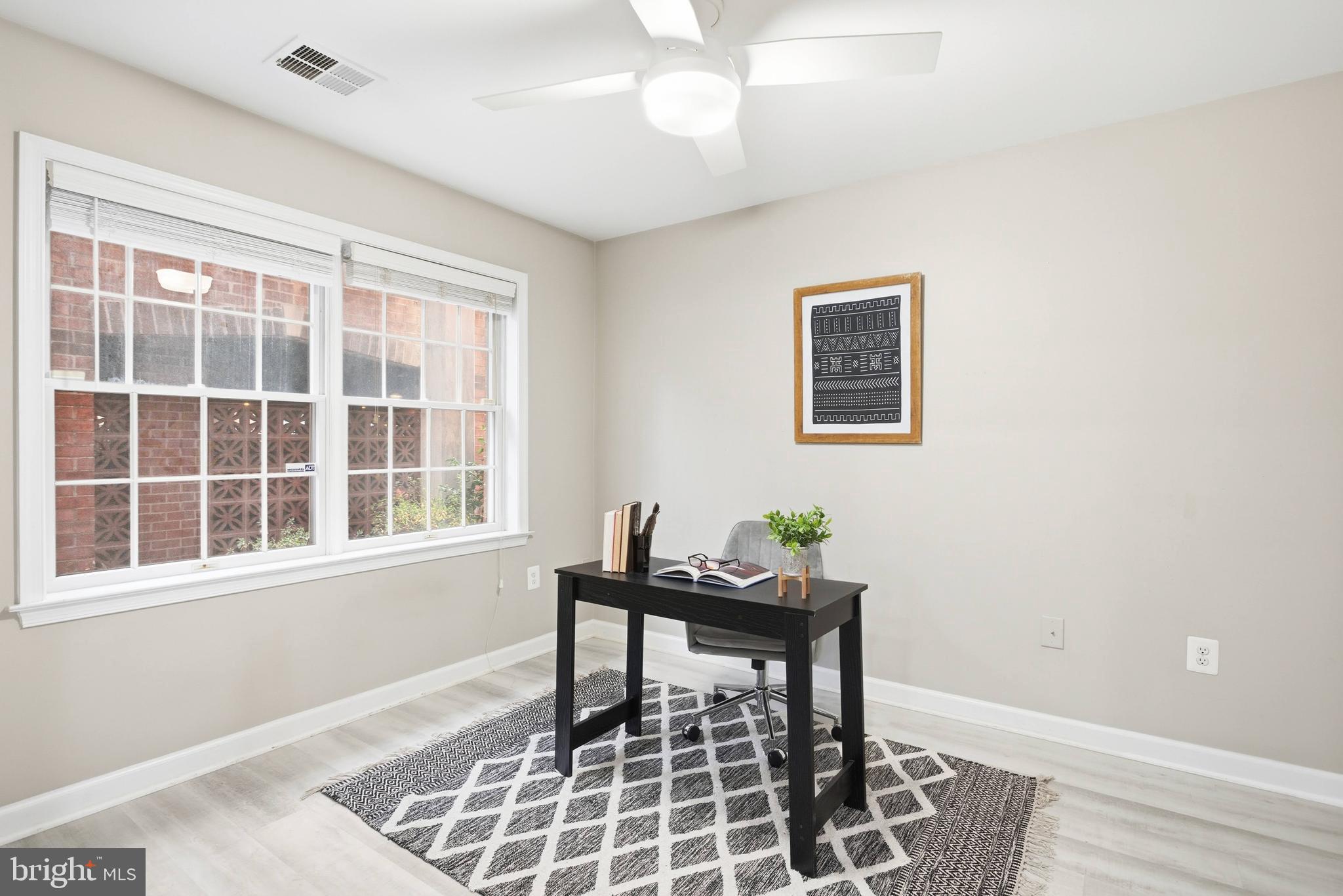 6924 Fairfax Drive, Unit 122 Arlington, VA 22213 - Photo 6 of 30 a workspace with wooden floor and a window