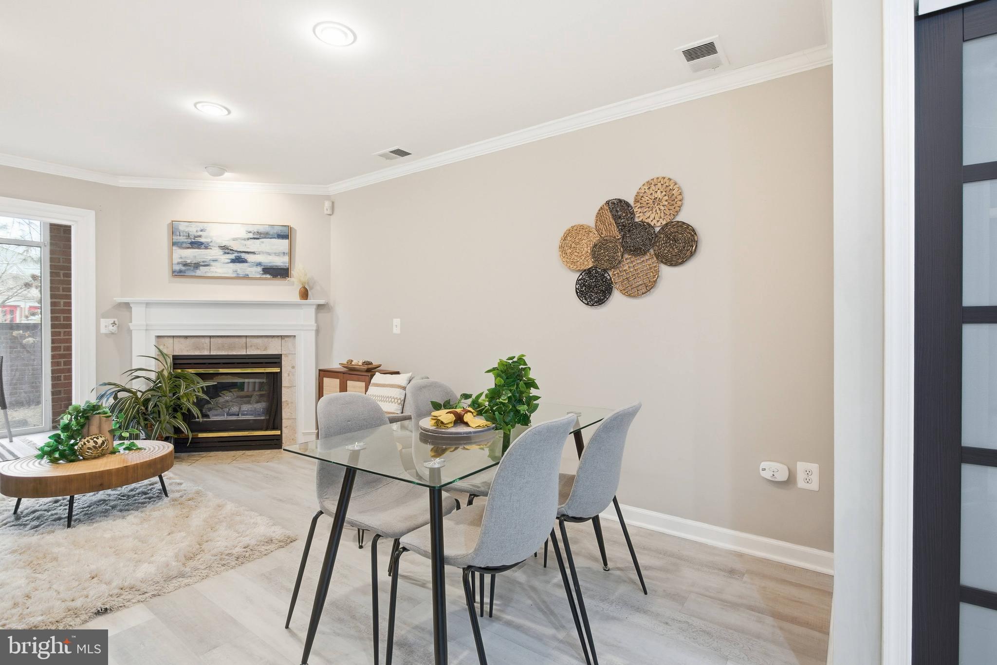 6924 Fairfax Drive, Unit 122 Arlington, VA 22213 - Photo 8 of 30 a dining room with furniture a fireplace and wooden floor