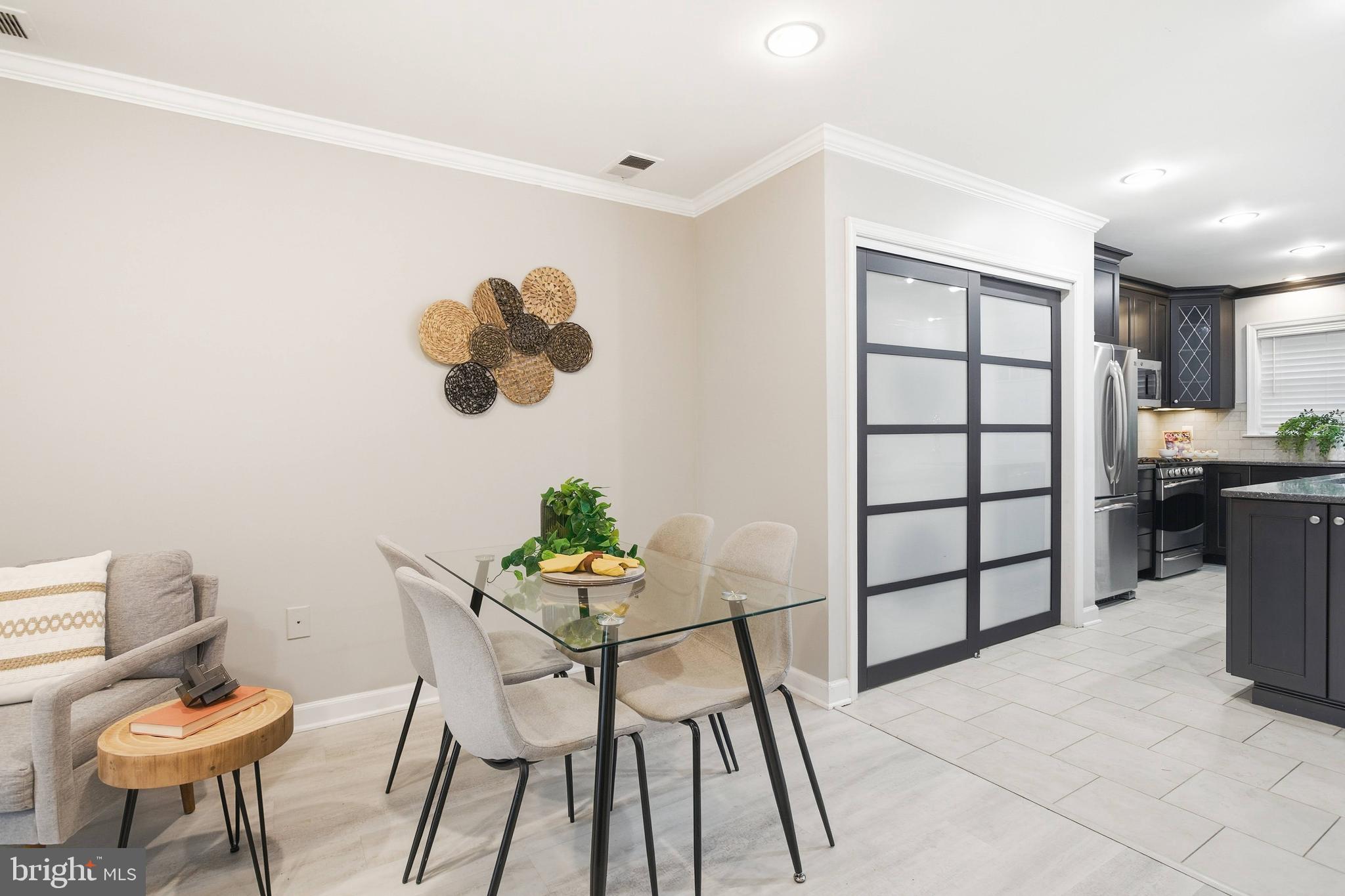 6924 Fairfax Drive, Unit 122 Arlington, VA 22213 - Photo 10 of 30 a view of a dining room with furniture and wooden floor