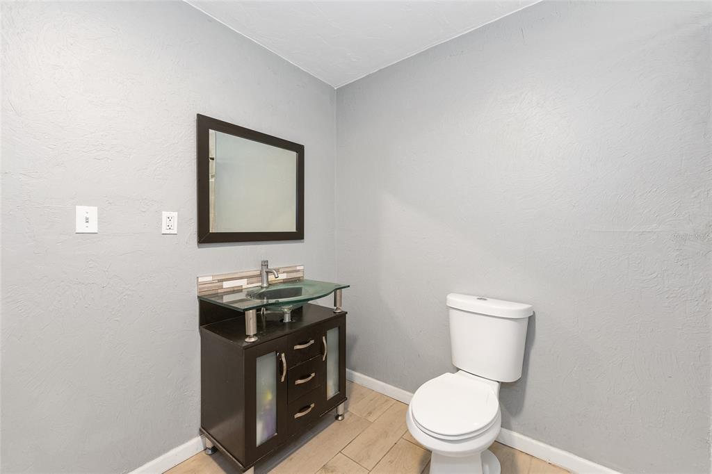15120 Northeast 35th Avenue Road Citra, FL 32113 - Photo 13 of 34 a bathroom with a toilet a sink and mirror