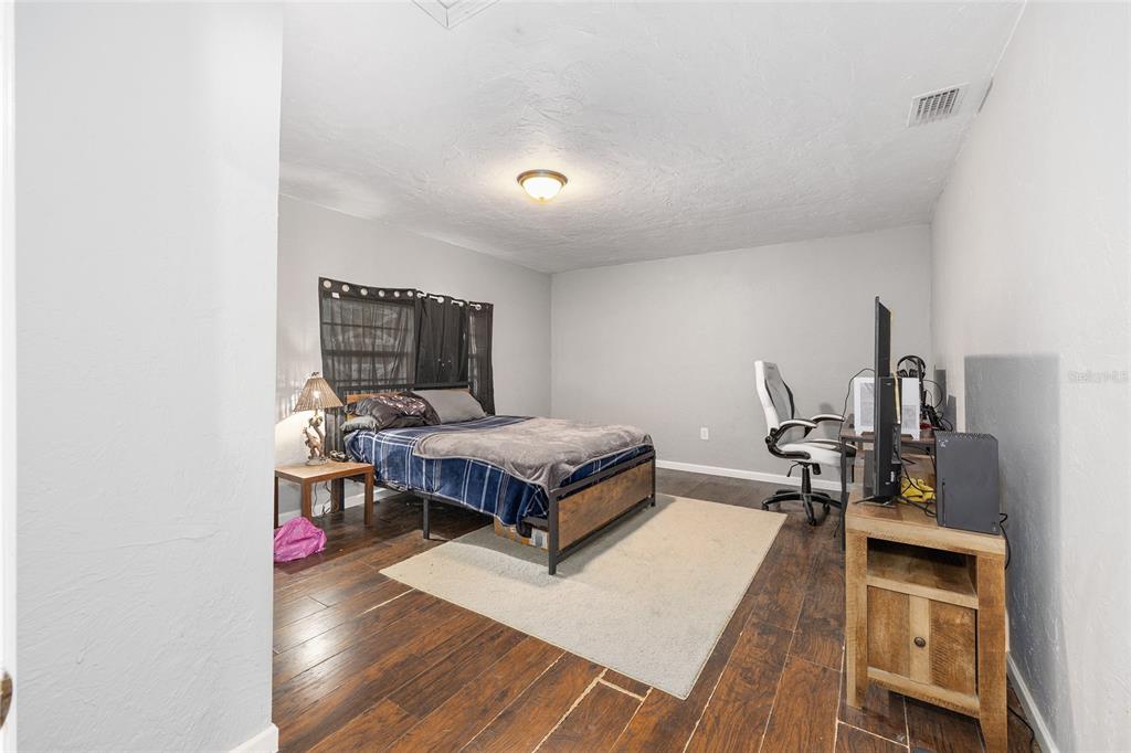 15120 Northeast 35th Avenue Road Citra, FL 32113 - Photo 14 of 34 a living room with a flat screen tv and gym equipment
