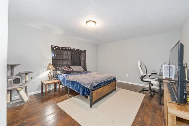 a bedroom with a bed and a flat screen tv
