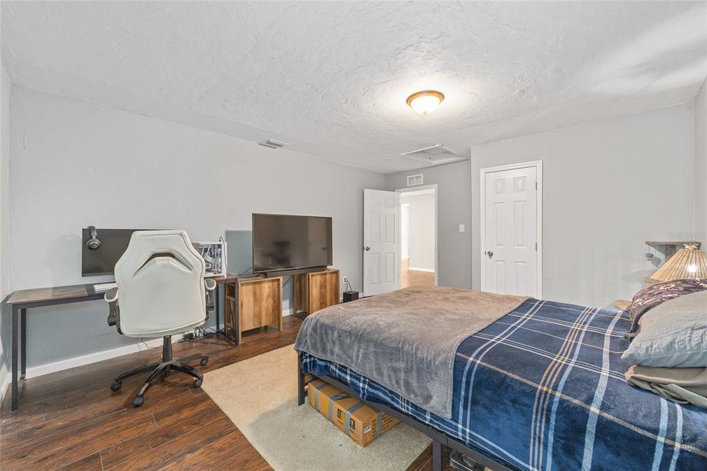 15120 Northeast 35th Avenue Road Citra, FL 32113 - Photo 16 of 34 a bedroom with a bed and a flat screen tv