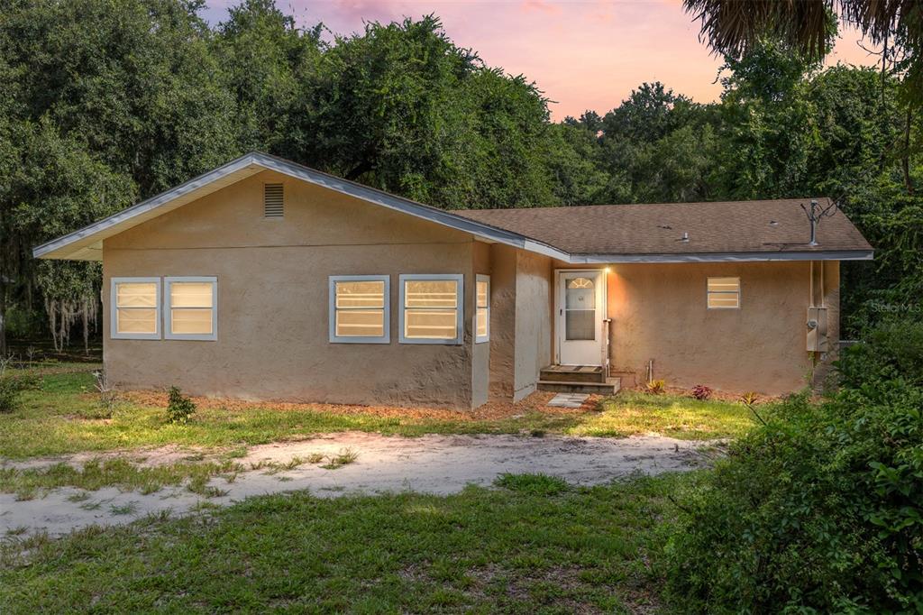 15120 Northeast 35th Avenue Road Citra, FL 32113 - Photo 2 of 34 a view of house with yard and trees in the background