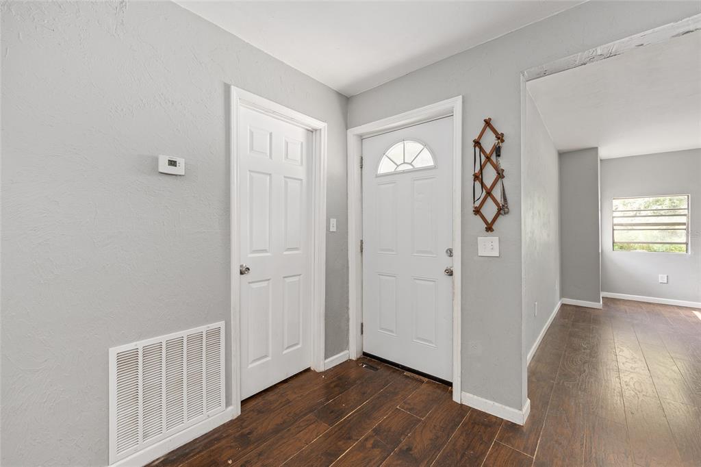 15120 Northeast 35th Avenue Road Citra, FL 32113 - Photo 23 of 34 an empty room with wooden floor and windows