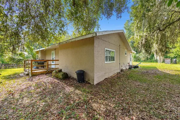 a view of backyard of house with green space