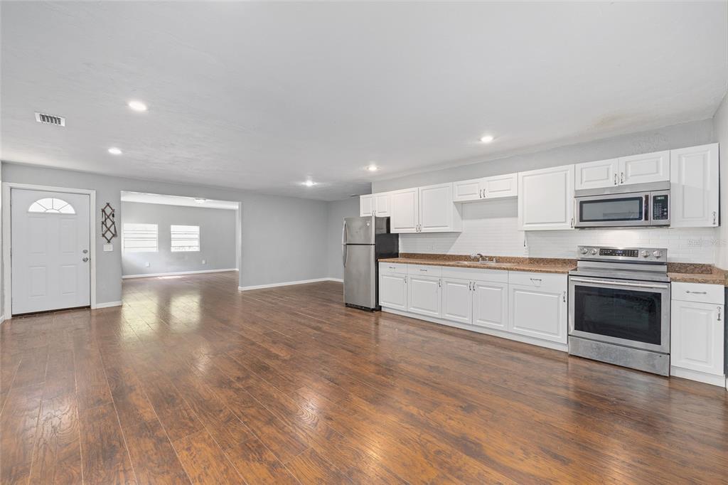 15120 Northeast 35th Avenue Road Citra, FL 32113 - Photo 4 of 34 a view of a kitchen with a sink stove cabinets and empty room