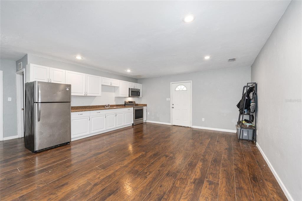 15120 Northeast 35th Avenue Road Citra, FL 32113 - Photo 5 of 34 a view of a kitchen with a fridge and wooden floor