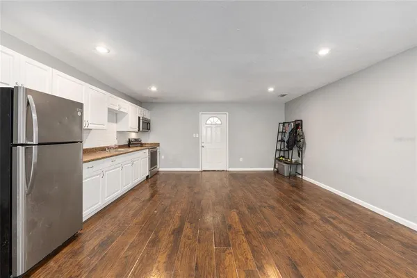 a spacious bedroom with a bed and a flat screen tv