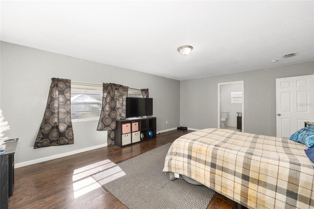 15120 Northeast 35th Avenue Road Citra, FL 32113 - Photo 9 of 34 a bedroom with a bed and a flat screen tv