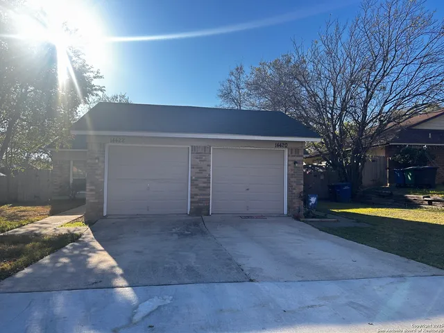 a view of a house with backyard and trees