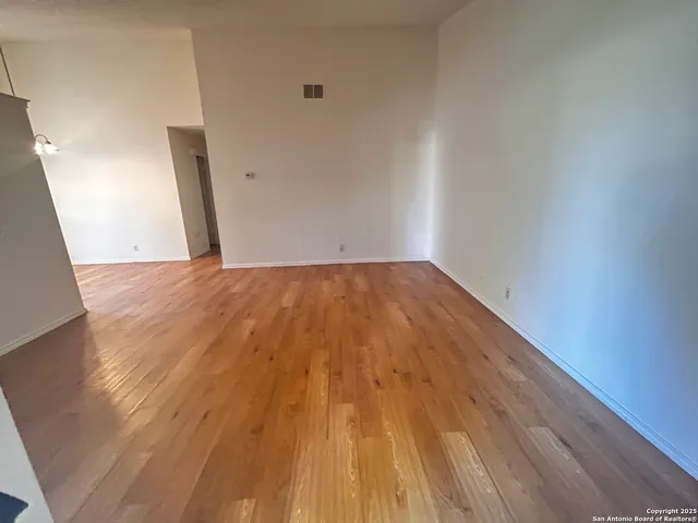 a view of a big room with wooden floor