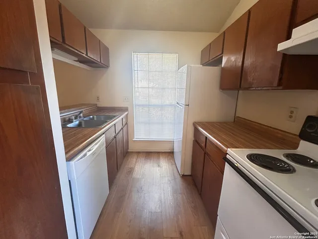 a kitchen with a stove and a refrigerator