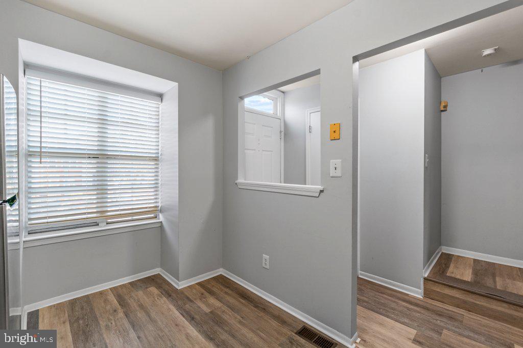 2412 Potterfield Road Windsor Mill, MD 21244 - Photo 11 of 36 a view of an empty room with wooden floor and a window