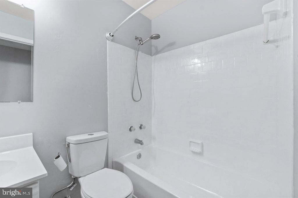 2412 Potterfield Road Windsor Mill, MD 21244 - Photo 22 of 36 a white toilet sitting next to a bath tub shower