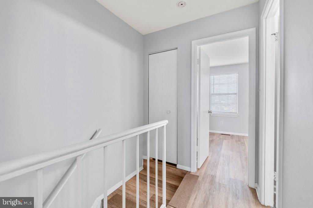 2412 Potterfield Road Windsor Mill, MD 21244 - Photo 23 of 36 a view of a hallway with wooden floor and entryway
