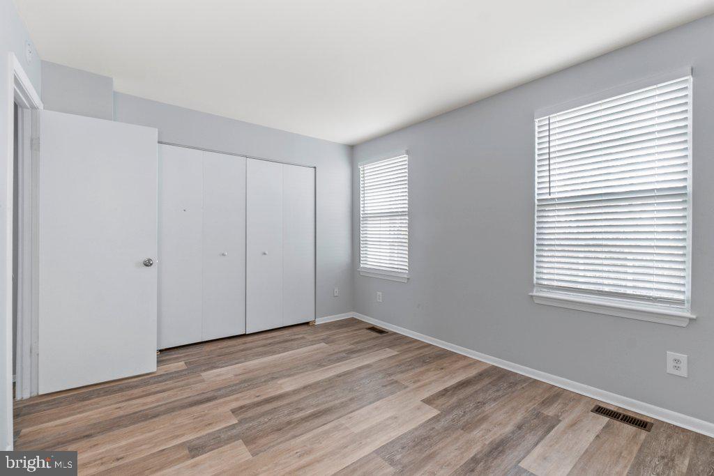 2412 Potterfield Road Windsor Mill, MD 21244 - Photo 24 of 36 an empty room with wooden floor and windows