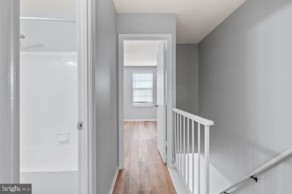2412 Potterfield Road Windsor Mill, MD 21244 - Photo 26 of 36 a view of a hallway with wooden floor and closet