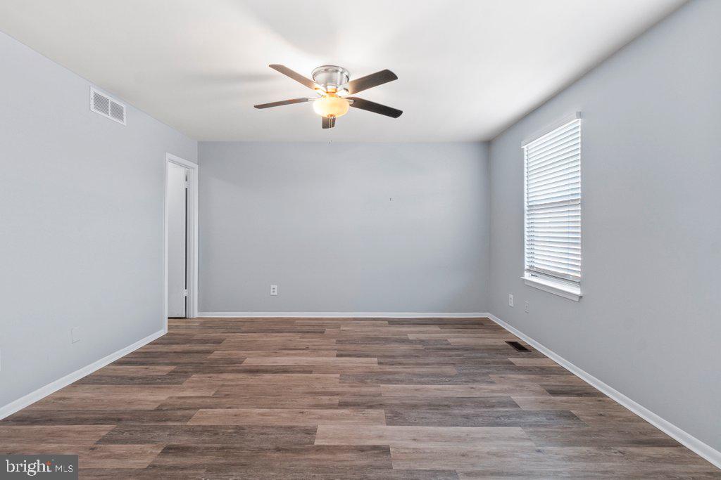 2412 Potterfield Road Windsor Mill, MD 21244 - Photo 27 of 36 a view of an empty room with window and wooden floor