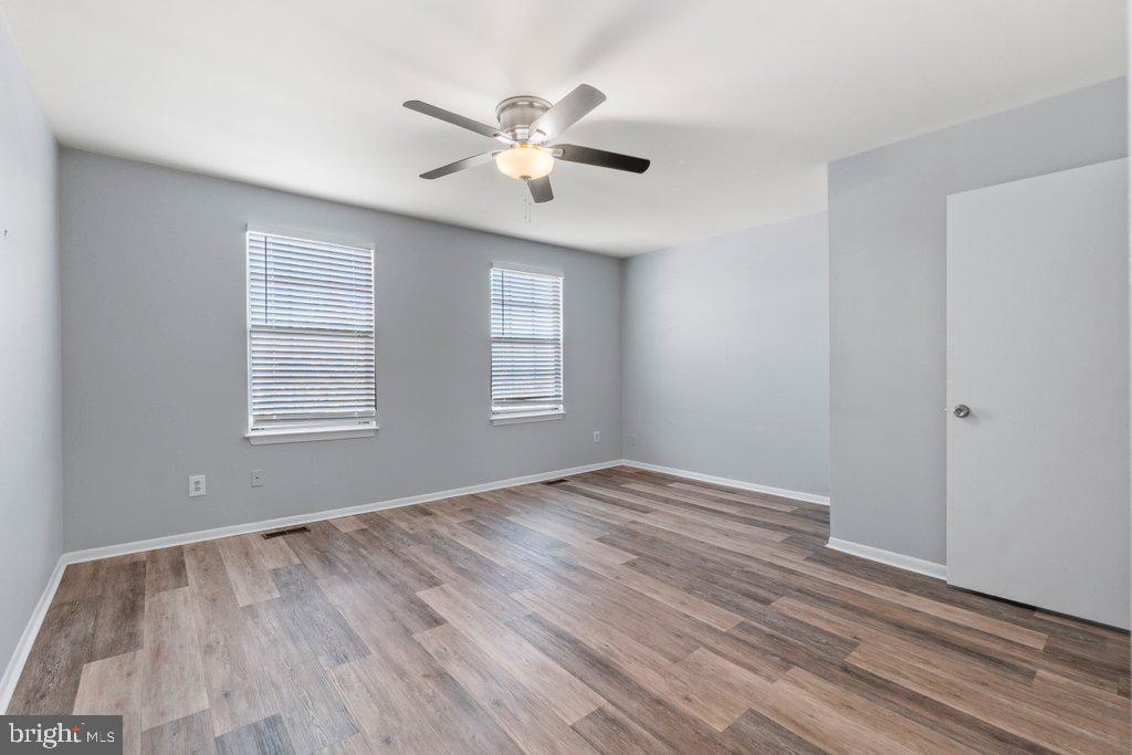 2412 Potterfield Road Windsor Mill, MD 21244 - Photo 28 of 36 a view of an empty room with wooden floor and a window