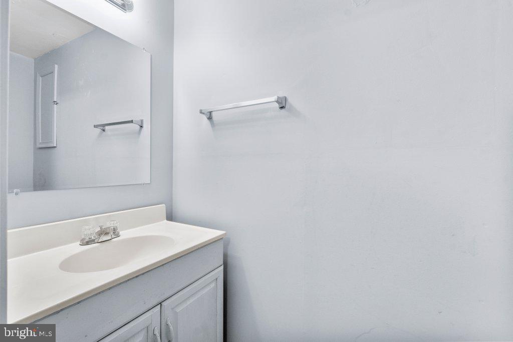 2412 Potterfield Road Windsor Mill, MD 21244 - Photo 33 of 36 a bathroom with a sink and a mirror