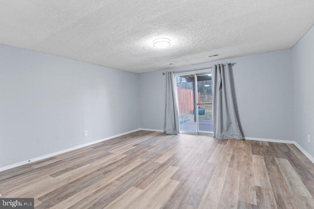 2412 Potterfield Road Windsor Mill, MD 21244 - Photo 35 of 36 a view of an empty room with wooden floor