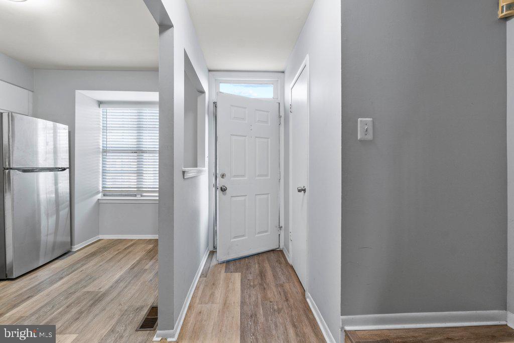 2412 Potterfield Road Windsor Mill, MD 21244 - Photo 7 of 36 a view of a hallway with wooden floor