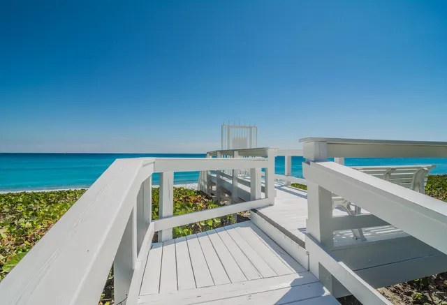 a view of a balcony with wooden floor and furniture