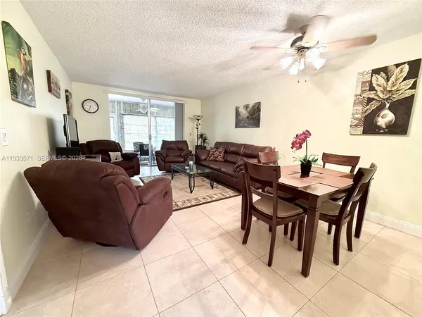 a living room with furniture a chandelier and a window