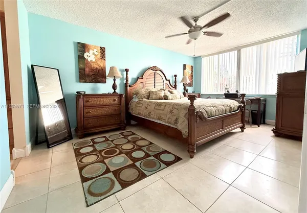 a bedroom with a bed dresser and a window