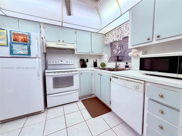 a kitchen with cabinets stainless steel appliances and a sink