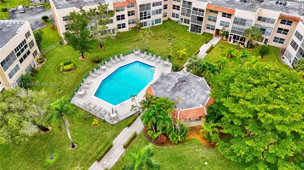 an aerial view of a house with a garden and swimming pool