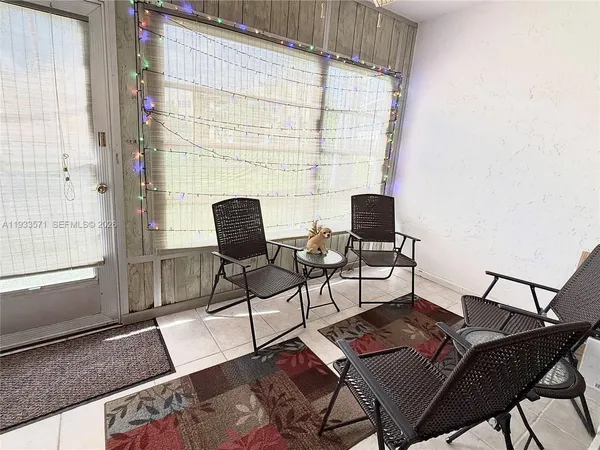 a living room with furniture and next to a window