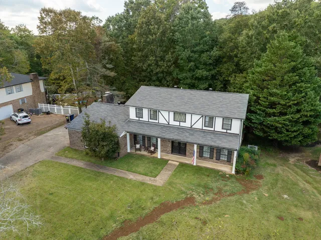 aerial view of a house with swimming pool next to a yard