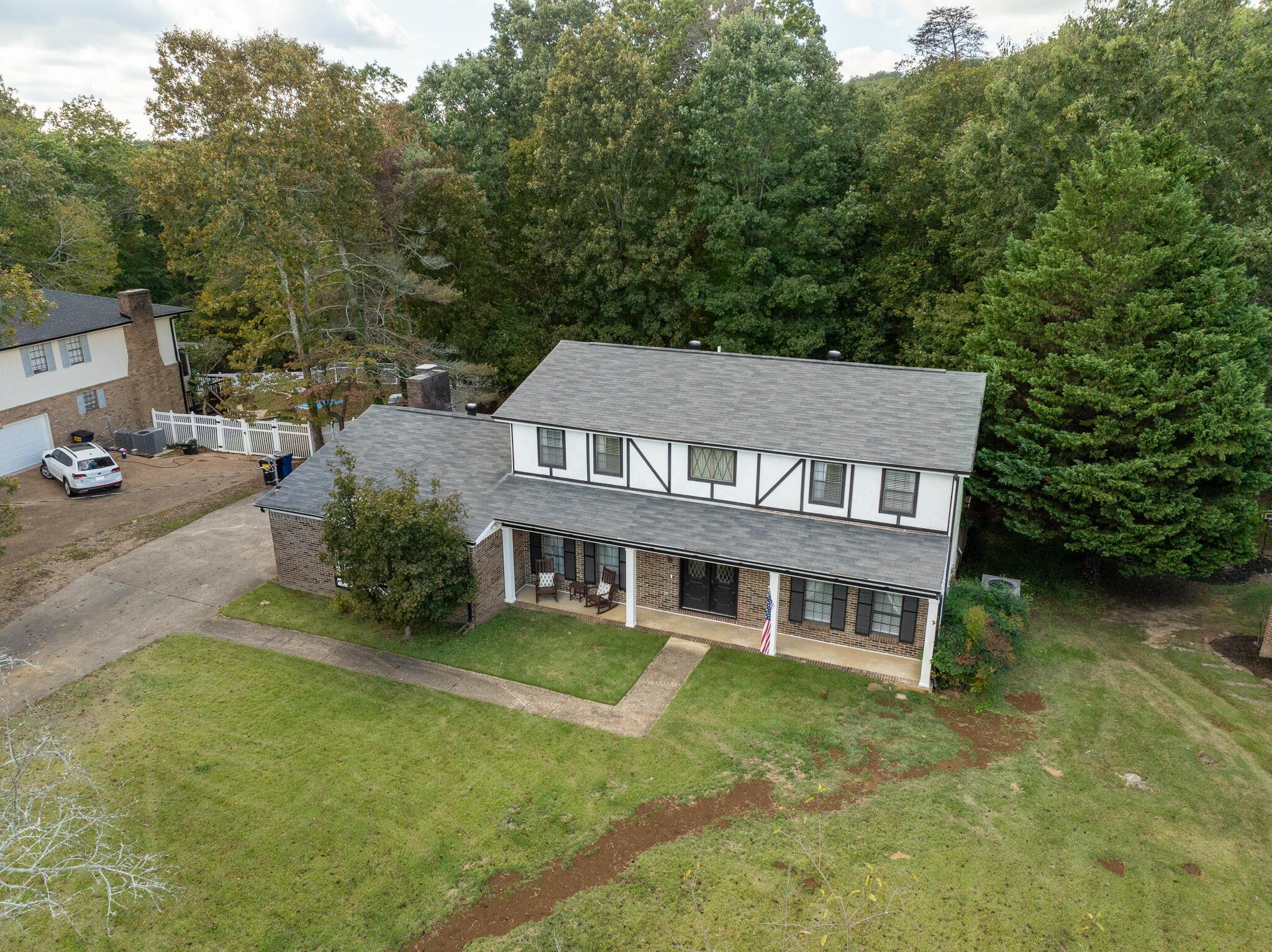 aerial view of a house with swimming pool next to a yard