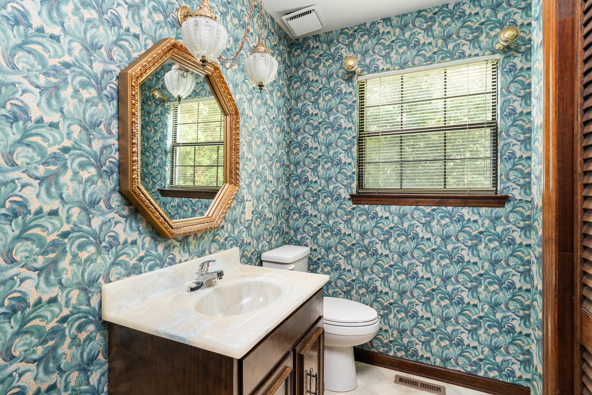 1820 Rock Bluff Road Hixson, TN 37343 - Photo 23 of 31 a bathroom with a sink a mirror and a toilet