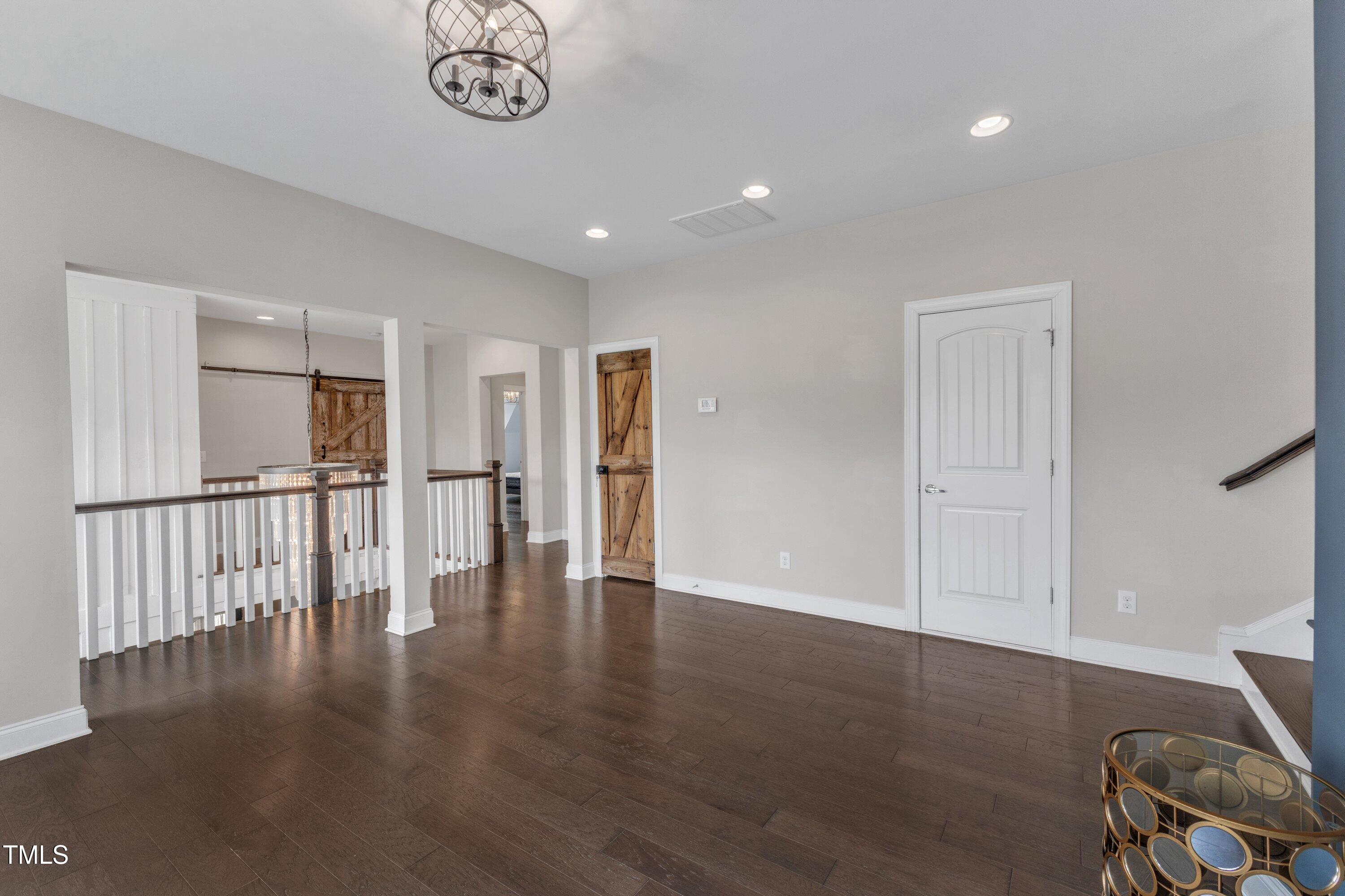 8121 Greys Landing Way Raleigh, NC 27615 - Photo 39 of 95 a view of empty room with wooden floor