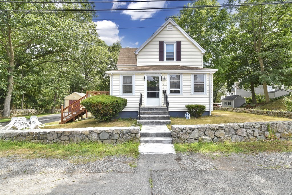 42 Vernon Street Boston, MA 02136 - Photo 2 of 12 a view of a white house with a yard and large trees