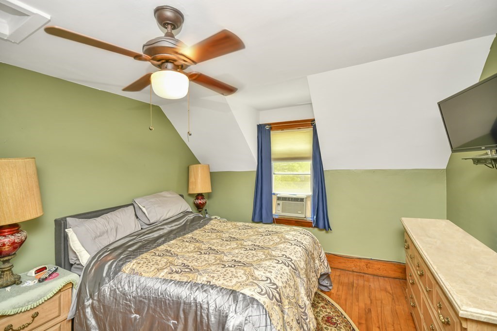 42 Vernon Street Boston, MA 02136 - Photo 7 of 12 a bedroom with a bed and a chandelier